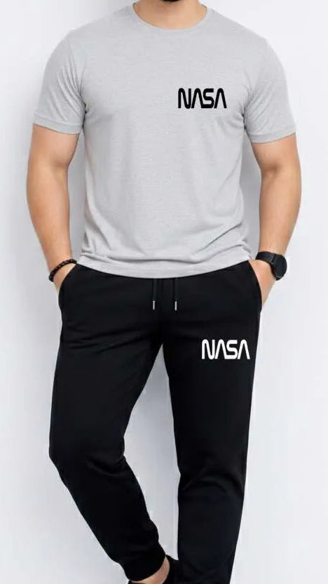 Person wearing a gray NASA t-shirt and black NASA pants on a white background